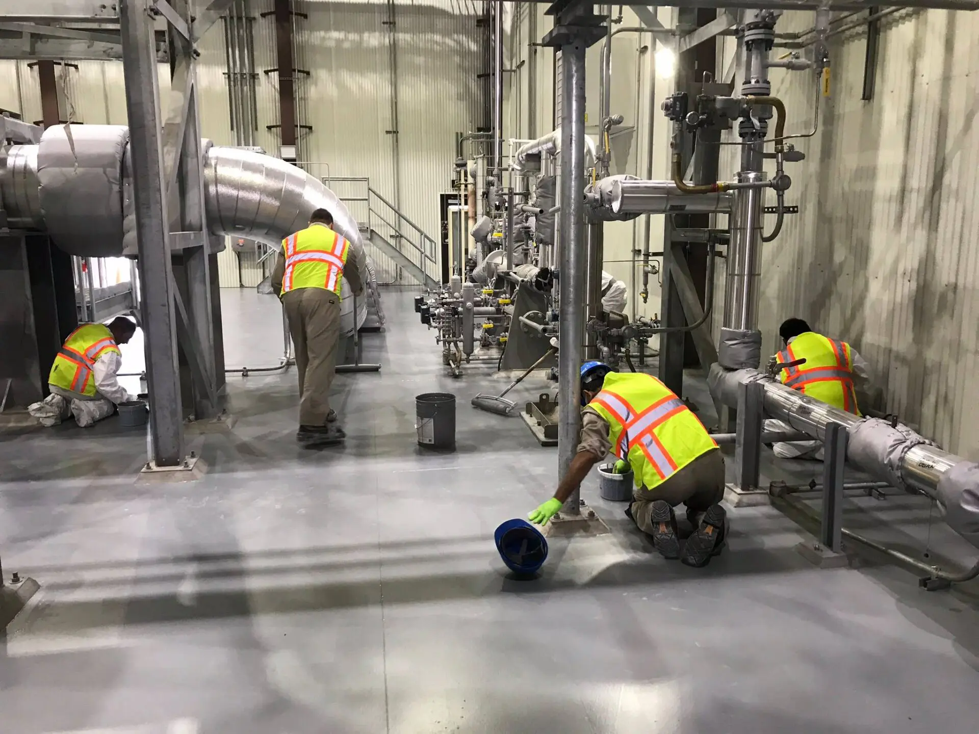 Workers putting non-slip layer on the floor